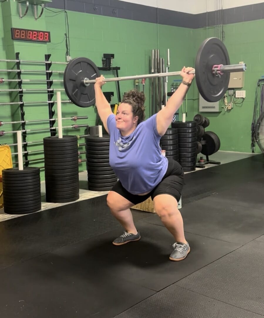 Woman snatching a barbell overhead